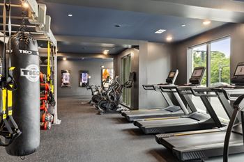 Cardio and strength training fitness center with eschelon and peloton bikes and fitness mirrors